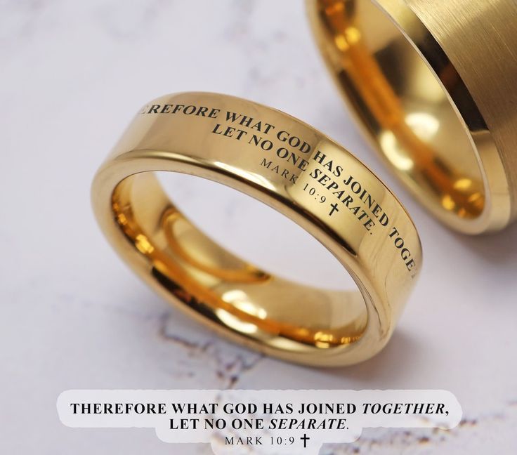 two gold wedding rings with the words before what god has done together, let no one separate