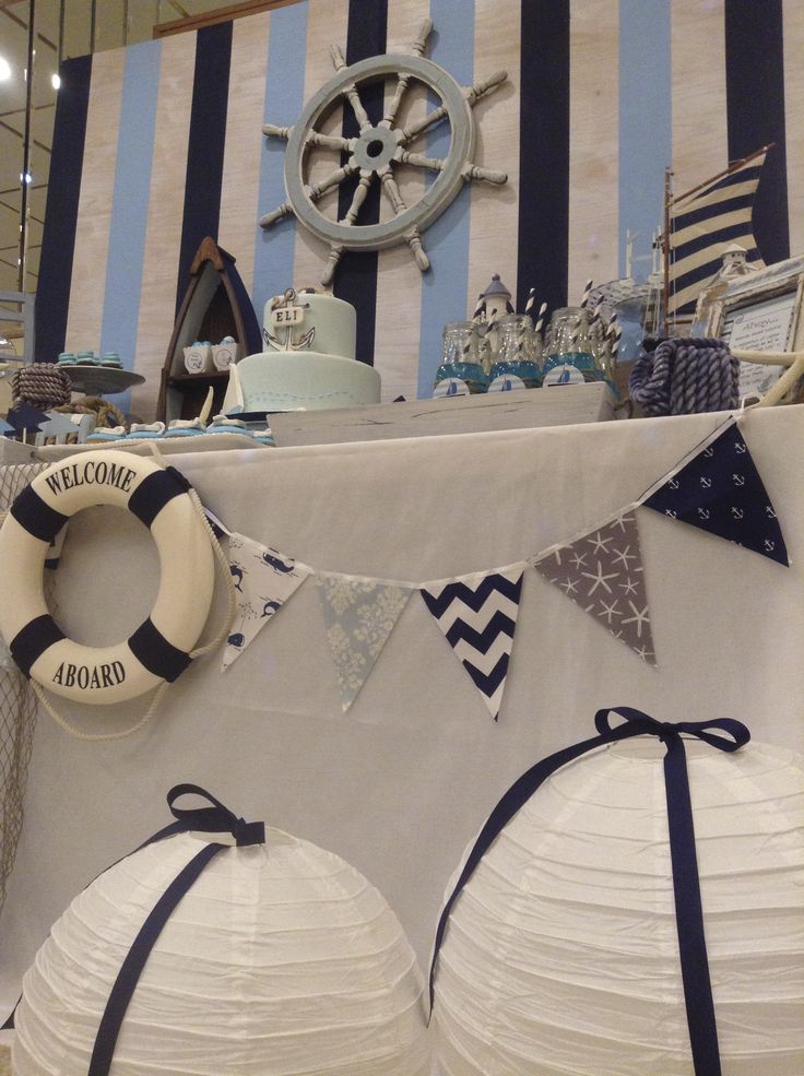 a table with paper lanterns and decorations on it at a boat party or wedding reception