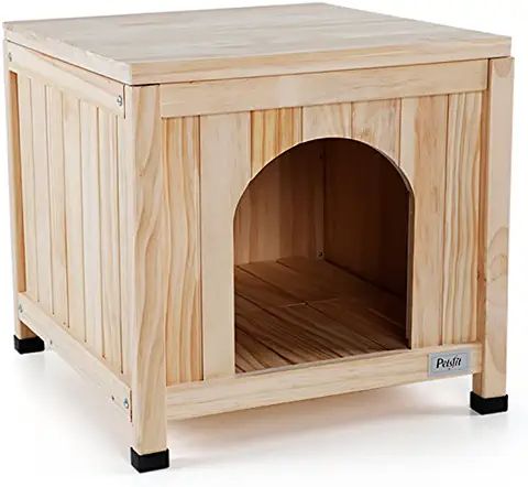 a small wooden dog house with its door open