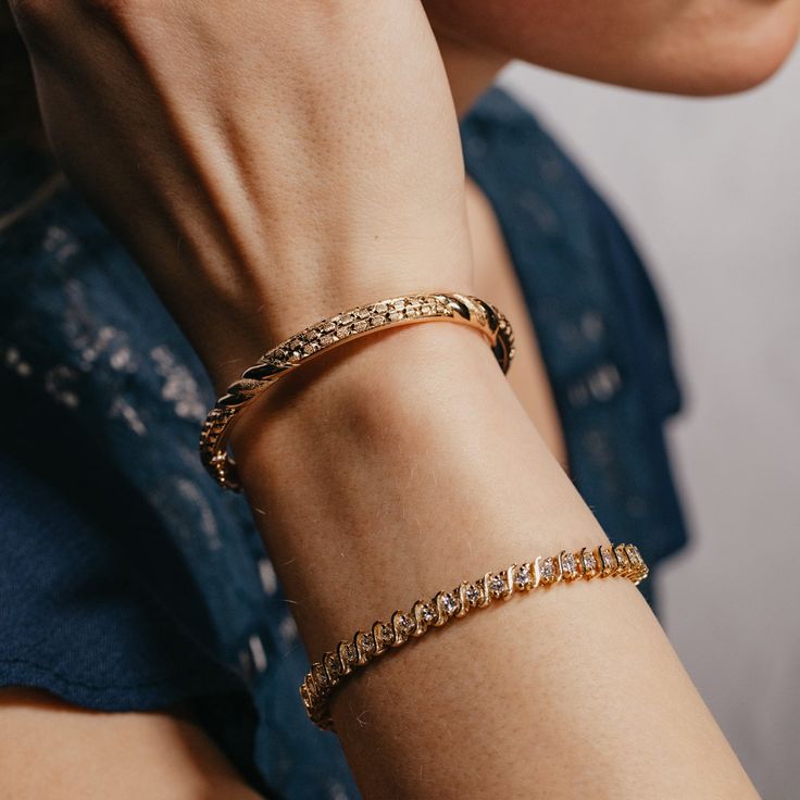 This 18k yellow gold bangle bracelet is hand engraved and features faceted and textured metal. It'll add warmth and sparkle to any look, perfect for any occasion! The inner circumference is 6.75 inches, and opens with a hinge for easy access. Its is held tightly in place with a security clasp. Pictured alongside the Yellow Gold & Natural Diamond Tennis Bracelet Timeless Diamond Cut Bangle Jewelry, Luxury Bangle Chain Bracelet With Single Cut Diamonds, Luxury Stackable Chain Bracelet For Formal Occasions, Formal Diamond Cut Bangle Cuff Bracelet, Luxury Formal Stackable Chain Bracelet, Fine Jewelry Diamond Cut Cuff Bracelet, Fine Jewelry Diamond Cut Bangle Chain Bracelet, Timeless Gold Stackable Tennis Bracelet, Formal Diamond Bangle Bracelet With Oyster Detail