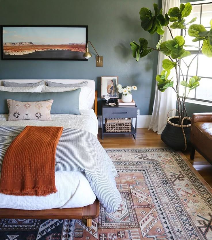 a bed sitting in a bedroom on top of a wooden floor next to a window