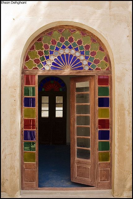 an open door with colorful stained glass on it