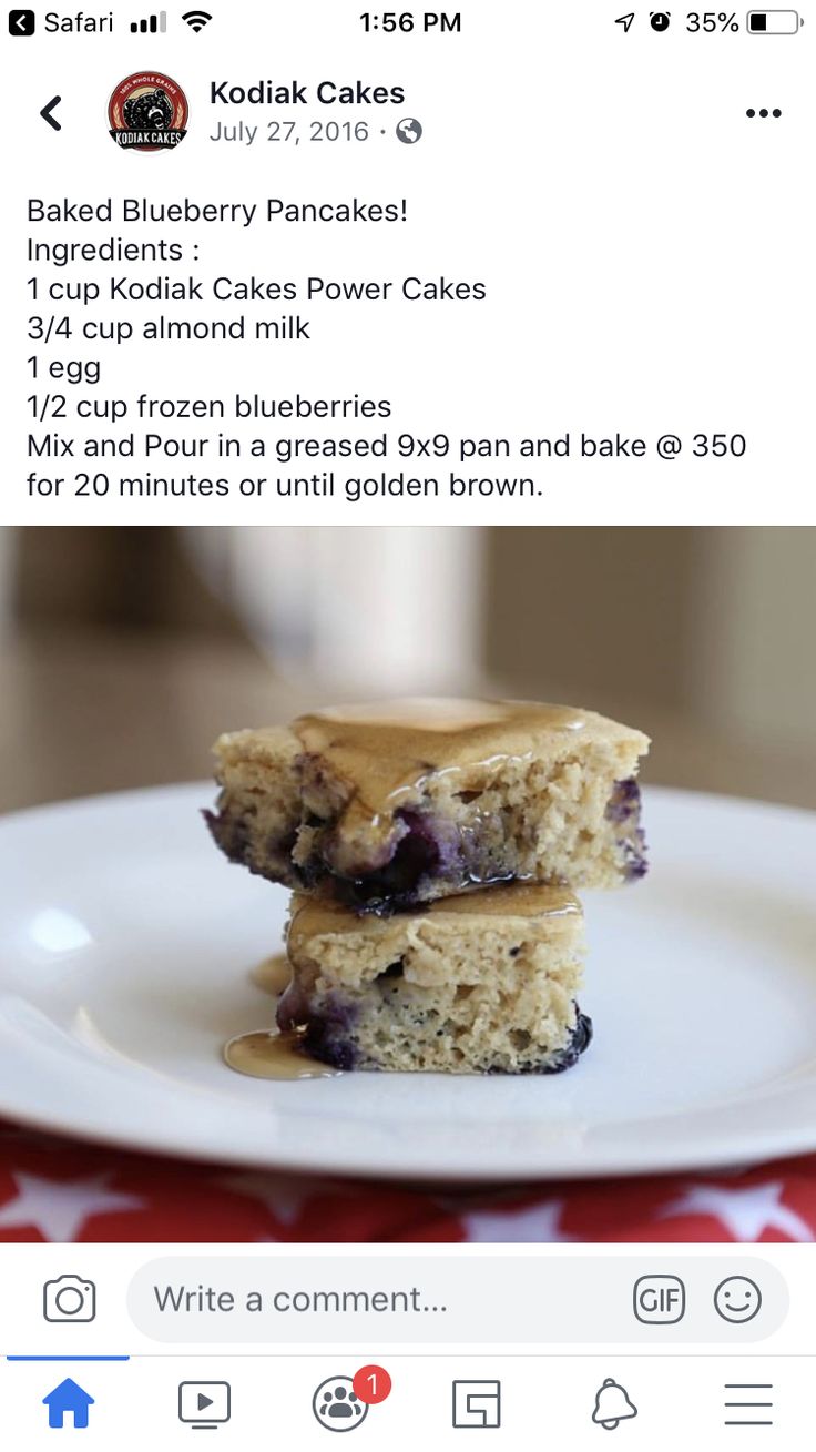 two pieces of cake sitting on top of a white plate with blueberries and peanut butter