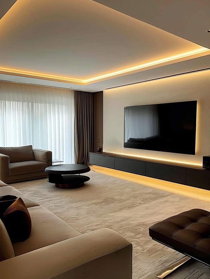 a living room with couches, chairs and a flat screen tv on the wall