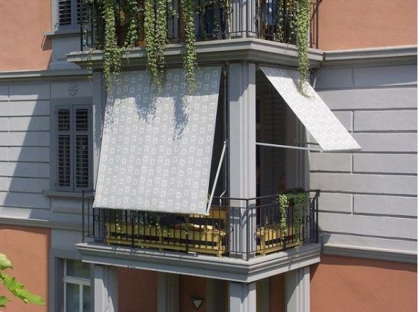 an apartment building with plants growing on the balcony and balconies hanging from the windows