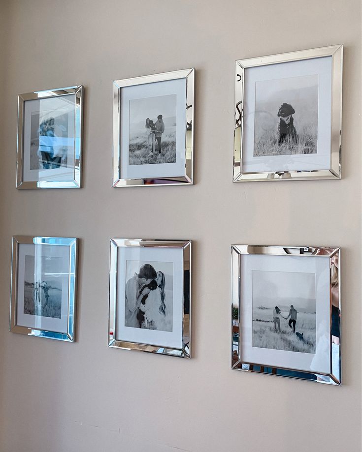 four silver framed pictures hang on the wall