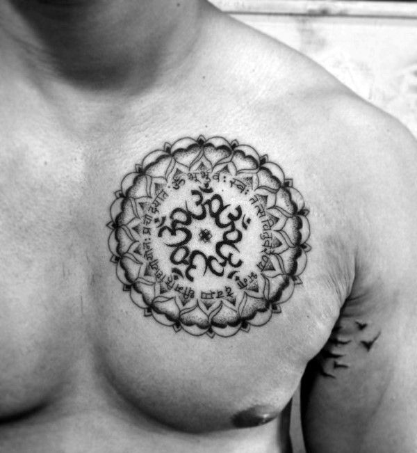 a man's chest with an ornamental tattoo design on his left shoulder and chest