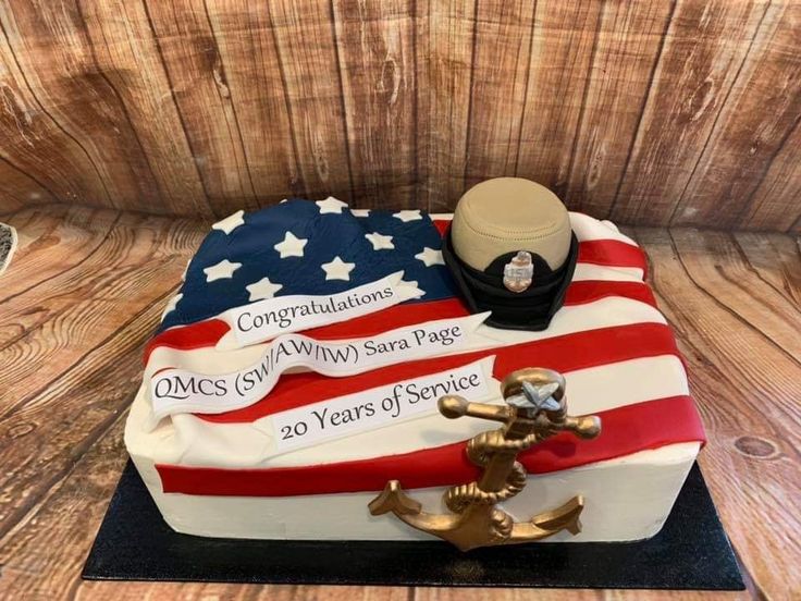 a cake decorated with an american flag and a marine's hat on top of it