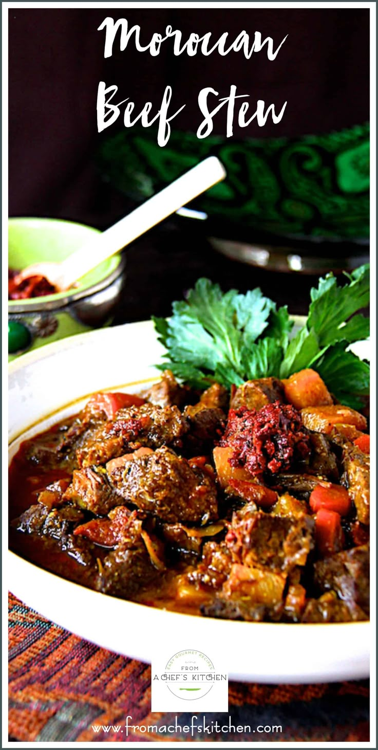 a white bowl filled with beef stew and garnished with parsley