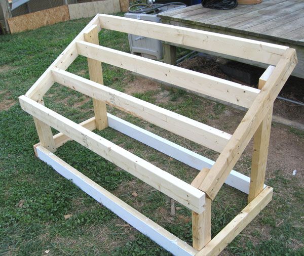 a wooden bench sitting on top of a grass covered field