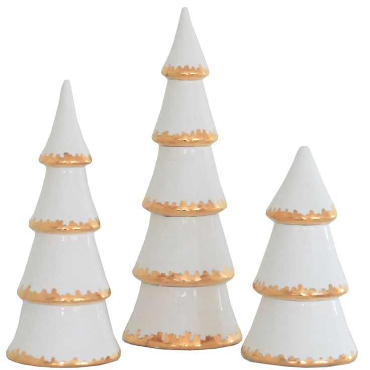 three white and gold decorated christmas trees