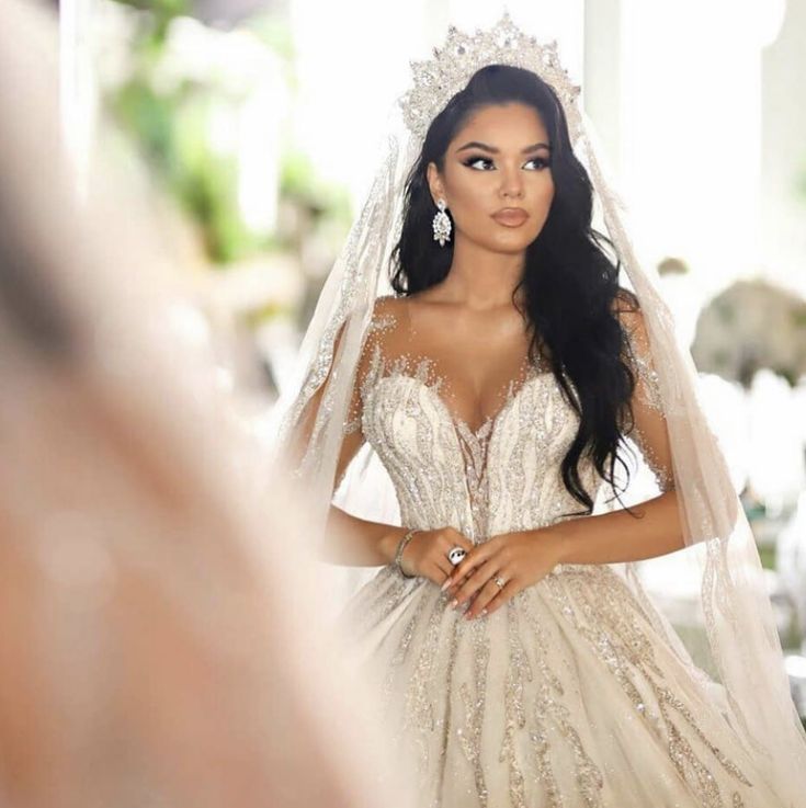 the bride is getting ready to walk down the aisle in her wedding dress and veil