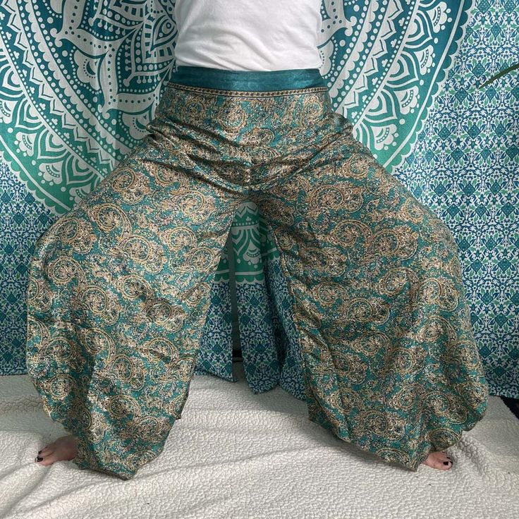 Wide Leg Silk Jeanie Pant. The lightweight and airy design will keep you cool.Material: SilkAdjustable WaistThis beautiful open pant is impressive and highly comfortable for dancing, perfect for a cruise, Pilates, night out, yoga, beach, festivals, holiday, relaxation, ordinary day, traveling, dance, and indoor and outdoor wear. Bohemian Stretch Bottoms For Vacation, Bohemian Stretch Pants For Vacation, Summer Stretch Wide-leg Parachute Pants, Stretch Wide-leg Parachute Pants For Summer, Hippie Stretch Bottoms For Beach, Stretch Harem Pants For Festivals, Stretch Harem Bottoms For Festival, Stretch Full Length Parachute Pants For Summer, Stretch Full-length Parachute Pants For Summer