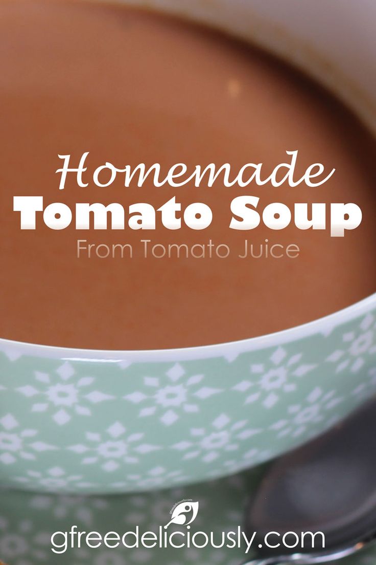 homemade tomato soup in a white bowl with spoons on the side and text overlay reads homemade tomato soup from tomato juice