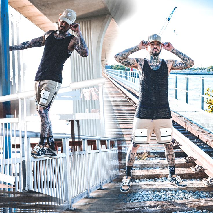 two men with tattoos standing on train tracks