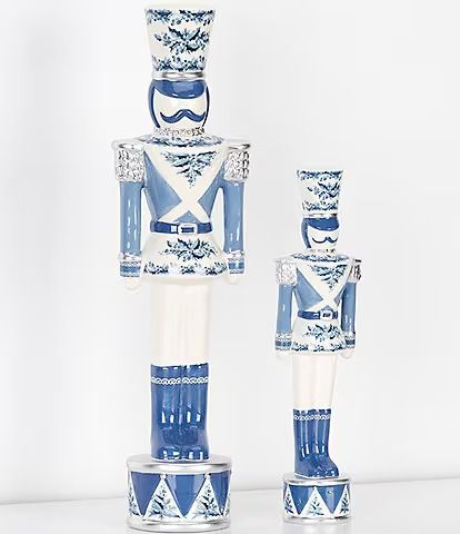 two blue and white ceramic nutcrackers are on display in front of a white background