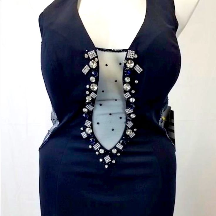 a mannequin wearing a black dress with beaded details