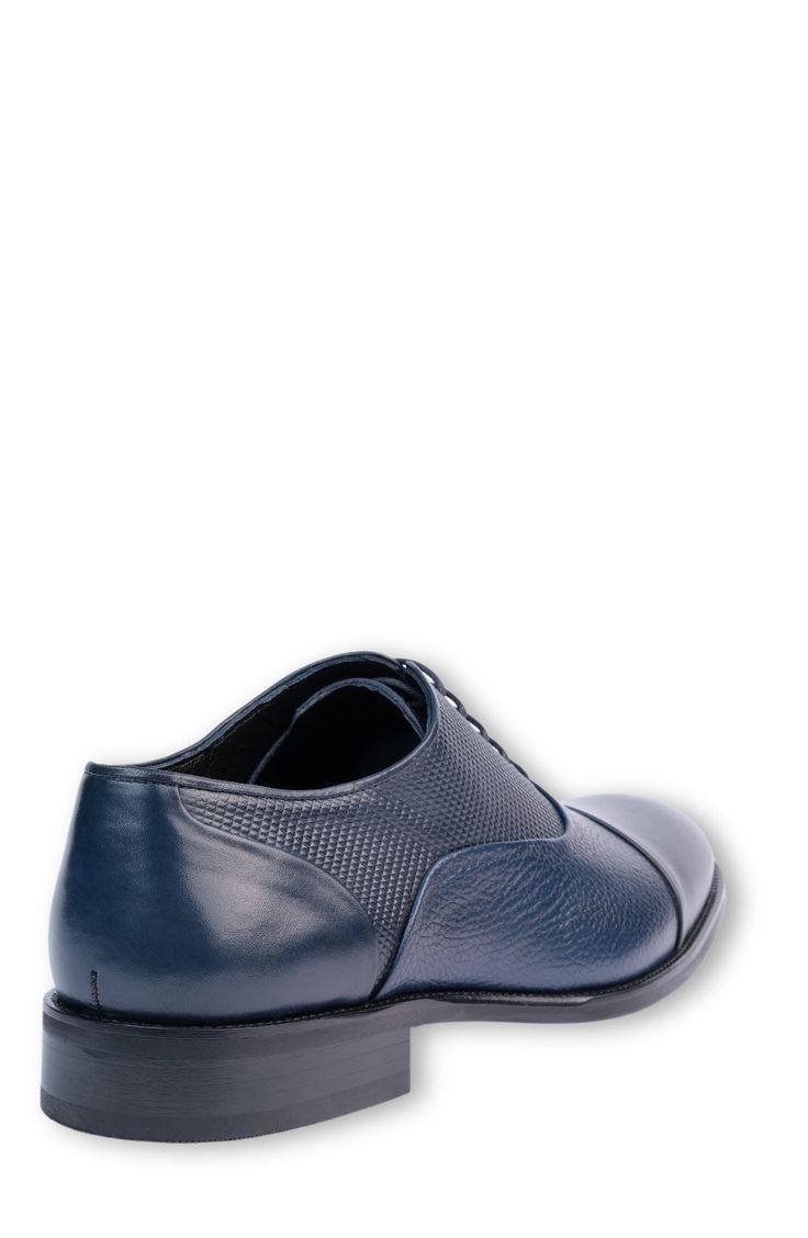 Elevate your wardrobe with a contemporary oxford constructed from smooth and textured leather in a sophisticated cap-toe silhouette. Lace-up style Leather upper and lining/synthetic sole Made in Turkey Fitted Blue Oxfords For Business, Blue Business Oxfords, Classic Blue Dress Shoes For Work, Blue Goodyear Welted Oxfords For Work, Classic Navy Oxfords With Brogue Detailing, Blue Cap Toe Oxfords For Office, Modern Cap Toe Oxfords For Business Casual, Elegant Blue Oxfords For Workwear, Classic Blue Oxfords For Derby