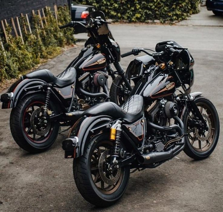 two black motorcycles parked next to each other