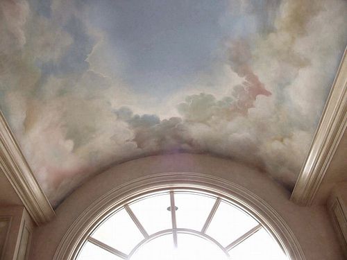 the sky is filled with clouds above a round window