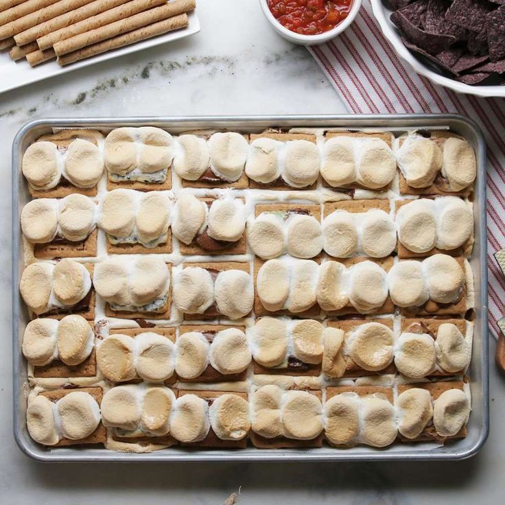 a baking pan filled with marshmallows and crackers