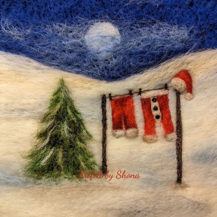 a felt christmas scene with santa's stockings and a fir tree