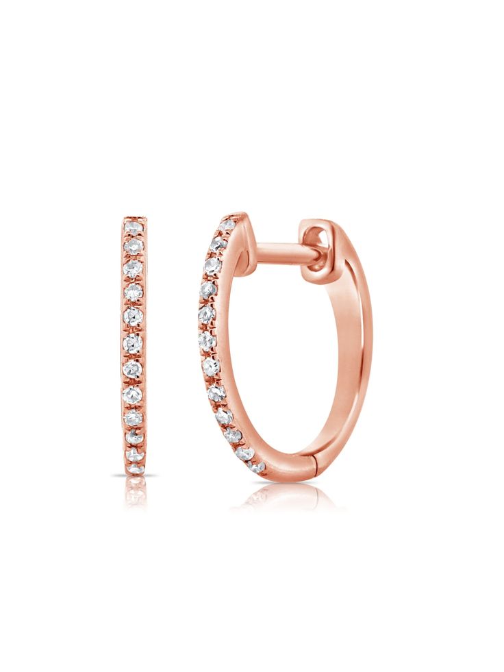 The classic diamond huggie gets a dainty delicate detail that breaks up the serenity of its sparkling stones. Crafted in 14K yellow, white or rose gold with .06ctw of round pave diamonds, these mini hoops offer a subtle sparkle and essential style. The design is so versatile you’ll want to reach for them every day. Available as a pair or a single. Rose Gold Huggie Hoop Earrings Vvs Clarity, Rose Gold Small Hoop Huggie Earrings With Diamond Accents, Everyday Rose Gold Diamond Earrings With Accents, Rose Gold Diamond Hoop Earrings With Single Cut Diamonds, Rose Gold Hoop Earrings With Single Cut Diamonds, Rose Gold Small Hoop Diamond Earrings, Classic Rose Gold Diamond Hoop Earrings, Everyday Rose Gold Huggie Diamond Earrings, Formal Rose Gold Huggie Earrings With Diamond Accents