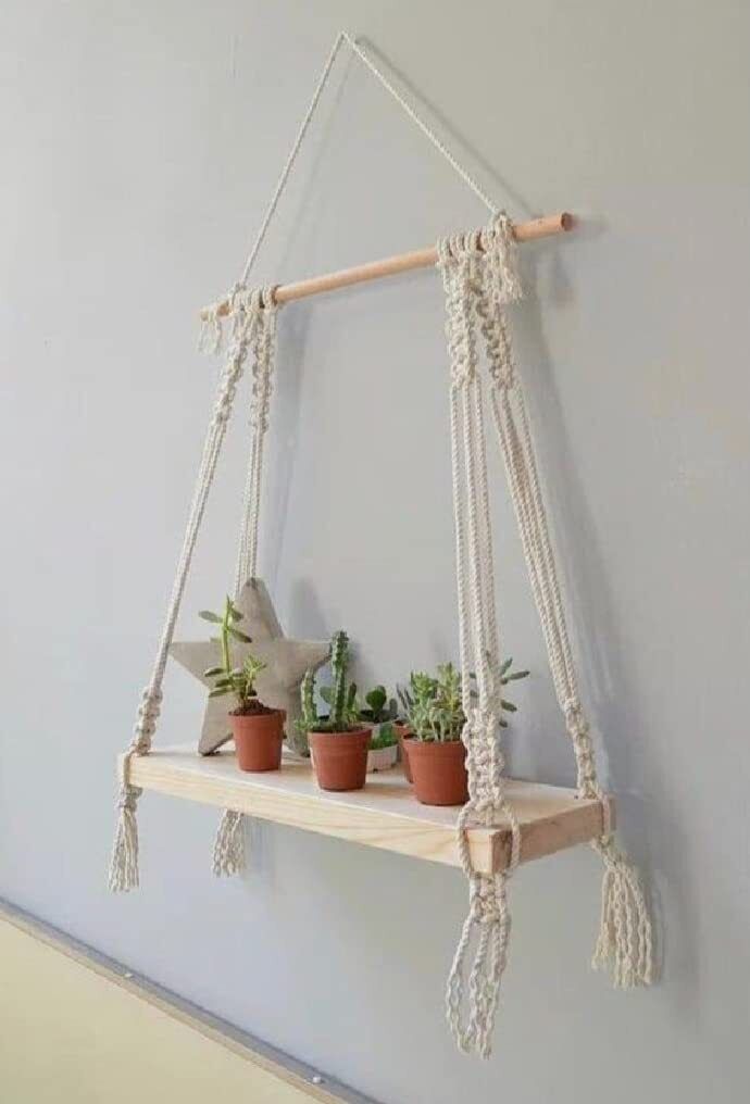 three potted plants sit on a shelf with macrame rope hanging from it