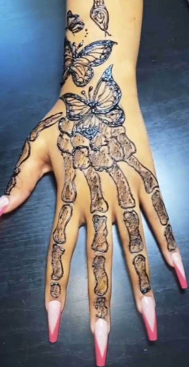 a woman's hand with tattoos on it