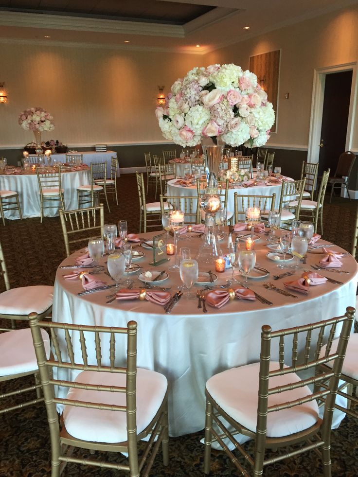 the tables are set with white and pink flowers