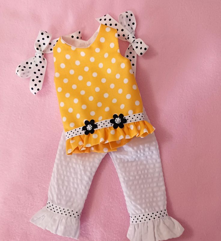 "Hi yall, this is a cotton polka dot tunic with seersucker pants and matching groisgrain hair ribbons. the tunic is completely lined and has a fabric ruffle at the bottom, there is a row of ribbon around the bottom, with two flower appliques' and polka dot buttons center front. the tunic closes  in the back with a strip of velcro top to bottom. the pants have an elastic waistband for easy dressing, the leg bottoms have a fabric ruffle, and  polka dot ribbon around the leg. this set fits 14\" dolls like wellie wishers, toni p 90, and many of the 1950 plastic dolls.   ( doll and props not  included ) . thank you so much for visiting                          please buy american made" Cotton Polka Dot Sets For Summer, Spring Cotton Sets With Polka Dot, Polka Dot Cotton Sets For Spring, Spring Cotton Polka Dot Sets, Cute Polka Dot Cotton Set, Spring Cotton Sets In Polka Dot, Spring Polka Dot Cotton Sets, Cute Polka-dotted Cotton Set, Fitted Polka Dot Sets For Spring