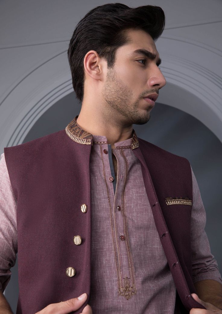 Waist Coat : Embroidered waistcoat in a deep maroon hue to layer over black shalwar kameez, for a perfect festive look. Details : Straight Front with Embellished band Plain Back, Band Neckline. Color : Maroon. Fabric : Melange winter fabric. Country of Origin : PakistanCare Instruction : Should be washed in gentle cycle and hung to dry. Color may bleed so please be mindful of other items with it.Disclaimer : Actual sizes might be slightly different from the size chart. Black Shalwar Kameez, Deep Wine Color, Embroidered Waistcoat, Maroon Fabric, Mens Waistcoat, Men's Waistcoat, Waistcoat Men, Deep Maroon, Waist Coat