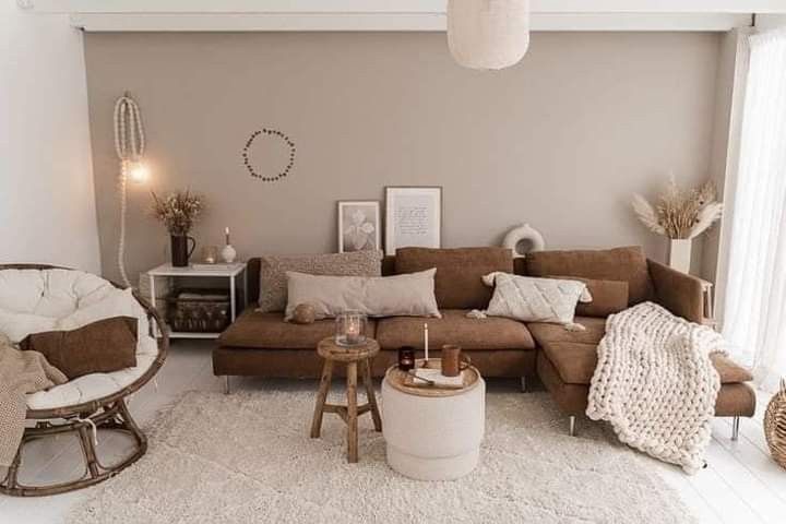 a living room filled with lots of furniture next to a white rug on the floor