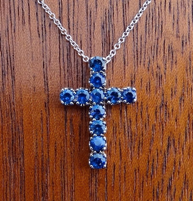 "This 18k white gold pendant is a high quality cross. This cross pendant measurements are 19.5mm height by 13.4mm width made in 18k white gold. It has 11 quality blue sapphire 1cts total weight. The 14k white gold chain can be 16,17 or 18 inch long . We love these pendant because it represents the way jewelry should be made with craftsmanship and quality. This pendent is anything but ordinary. Our pieces are designed and made with craftsmanship and sustainability in mind, our designs are made wi White Gold Cross Pendant, Oval Diamond Solitaire, Star Of David Pendant, Van Nuys, Gold Cross Pendant, White Gold Chains, Blue Sapphire Diamond, Diamond Cross Pendants, Birthstone Pendant