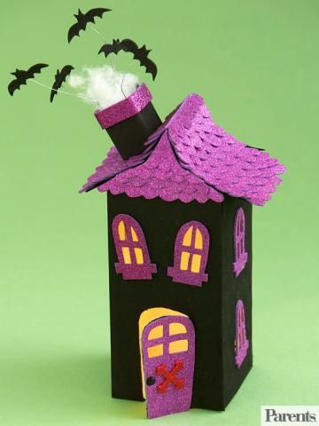 a paper house with bats coming out of it