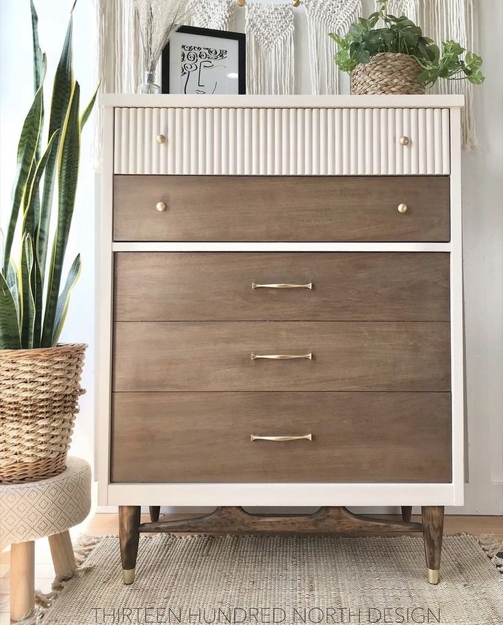 a white and brown dresser with plants on top