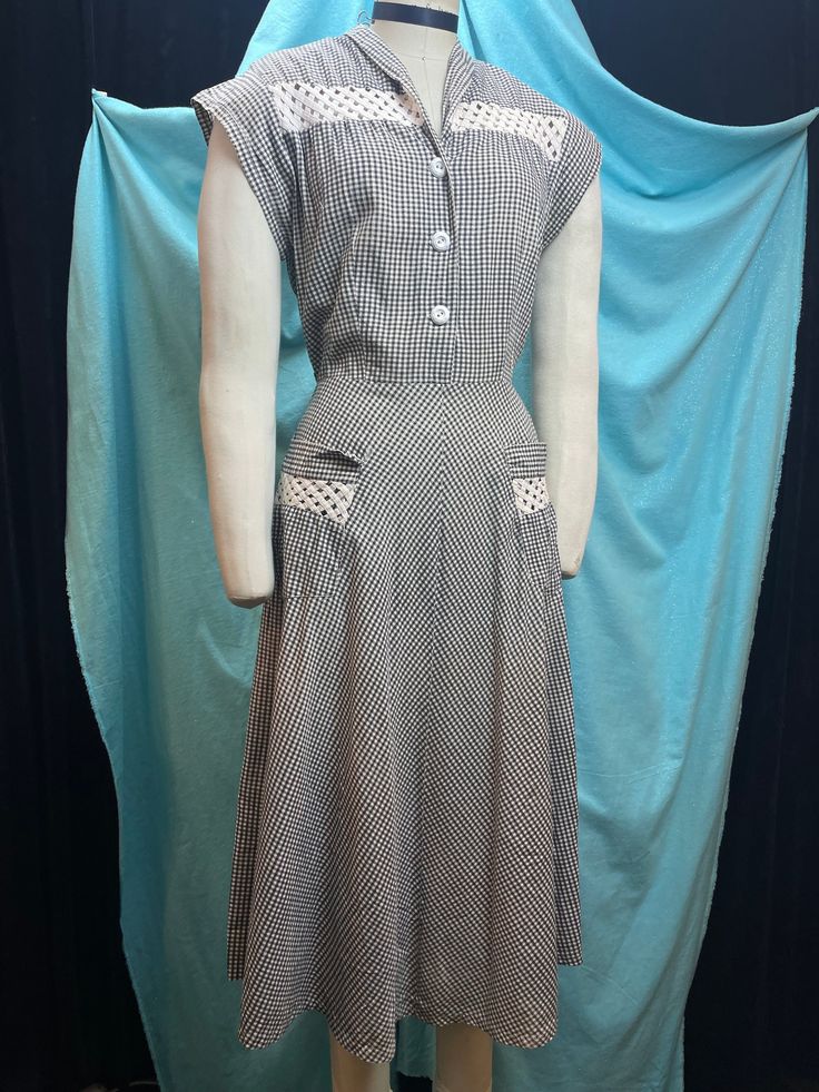 "1940s/1950s W:31 J.C Penney Brentwood Vintage Gingham Plaid Shirt dress Collared short sleeve Wicker trim Button up A-line shirtwaist  Great 40s/50s dress from vintage J C Penney. Lined as their line Brentwood cotton, from where the cotton mill was. Black and white gingham with wicker see through trim on the bodice and two front pockets. Shirt dress silhouette with collar annd three buttons, button down. No zipper but side andded 3-5\" with buttons to regulate, does the job if needed. Paneled c Gingham Dress With Short Sleeves And Button Closure, Classic Short Sleeve Gingham Dress, Classic Short Sleeve Vintage Dress For Daywear, Classic Gingham Short Sleeve Dress, Classic Vintage Short Sleeve Dress For Daywear, Vintage Gingham Dress With Short Sleeves, Classic Gingham Dress With Short Sleeves, Short Sleeve Vintage Dress With Button Closure, 1950s Style Vintage Dress With Short Sleeves For Daywear