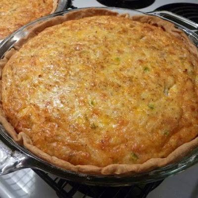 two pies sitting on top of an oven next to each other in pans