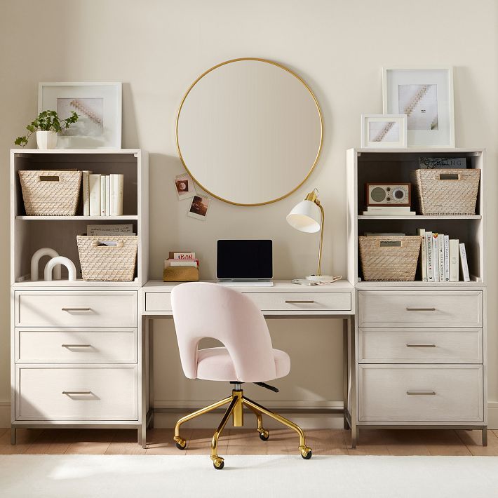 a white chair sitting in front of a desk with a round mirror on top of it