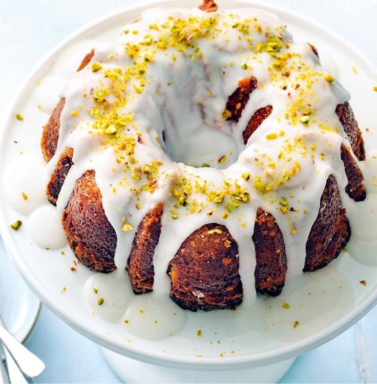 a bundt cake with white icing and yellow sprinkles