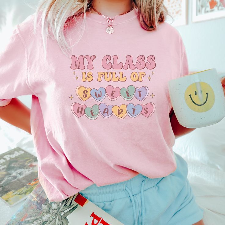 This cute shirt will be the perfect gift as a valentines day gift, comfort colors Shirt, Teacher Valentine's Day Tee, Teacher Appreciation Gift, 1st grade Teacher Shirt, 2nd Grade Teacher Gift, valentine's day shirt.*** INFO ***- 100% ring-spun cotton- Medium fabric (6.1 oz/yd² (206.8 g/m²))- Comfort Colors 1717- Sewn-in twill label- Relaxed fit- Garment-dyed fabric- Depending on what device you are viewing listing color may vary slightly.- Mockups might not be 100% accurate*** SIZES***- Please Cute Teacher Outfits, Kids Candles, Teacher Valentines, Candle Bags, Gifts Book, Teacher Clothes, Trendy Tees, Teaching Outfits, Sweet Hearts