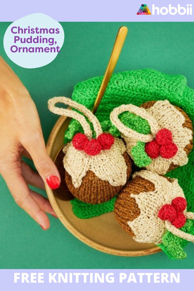 a knitted christmas pudding ornament on a plate with a woman's hand next to it