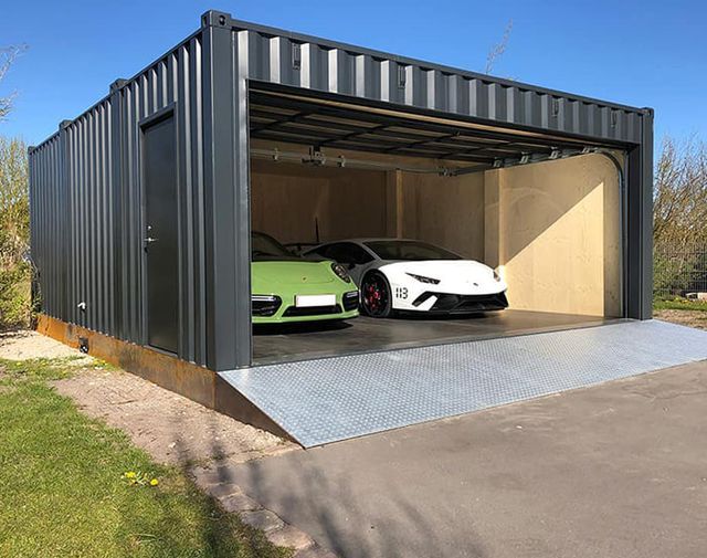 two cars are parked in the open garage