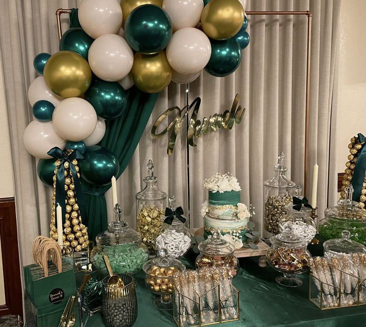 a table topped with lots of desserts and balloons