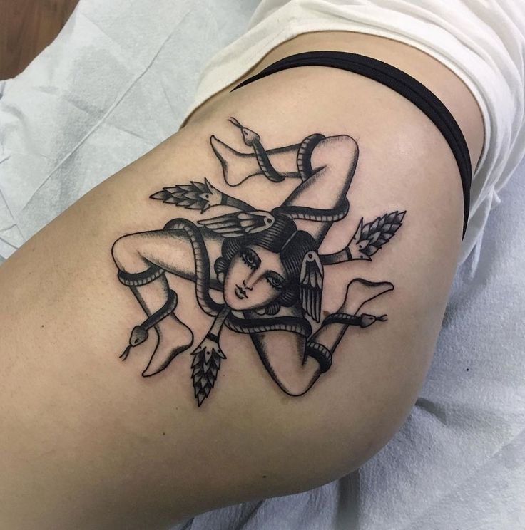 a woman's thigh with an arrow and girl tattoo on her left side ribcage