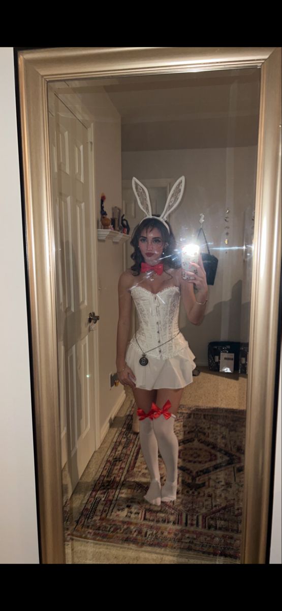 a woman in bunny ears is taking a selfie