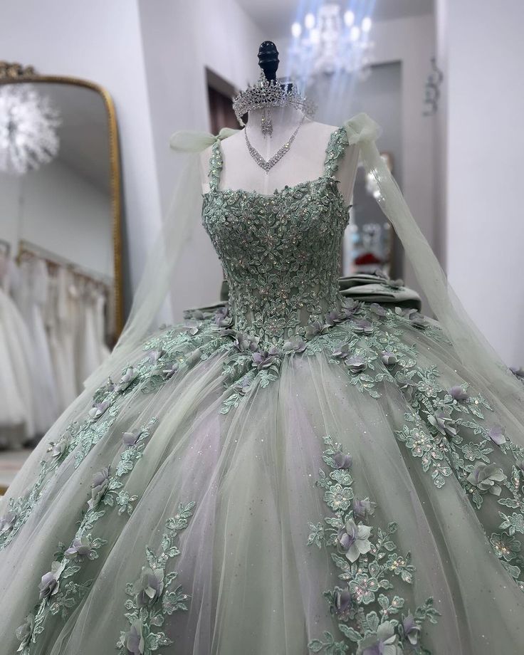 a dress on display in a store window with a mannequin wearing a tiara