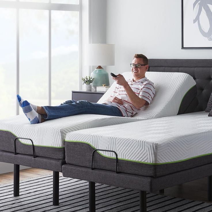 a man laying on top of two mattresses