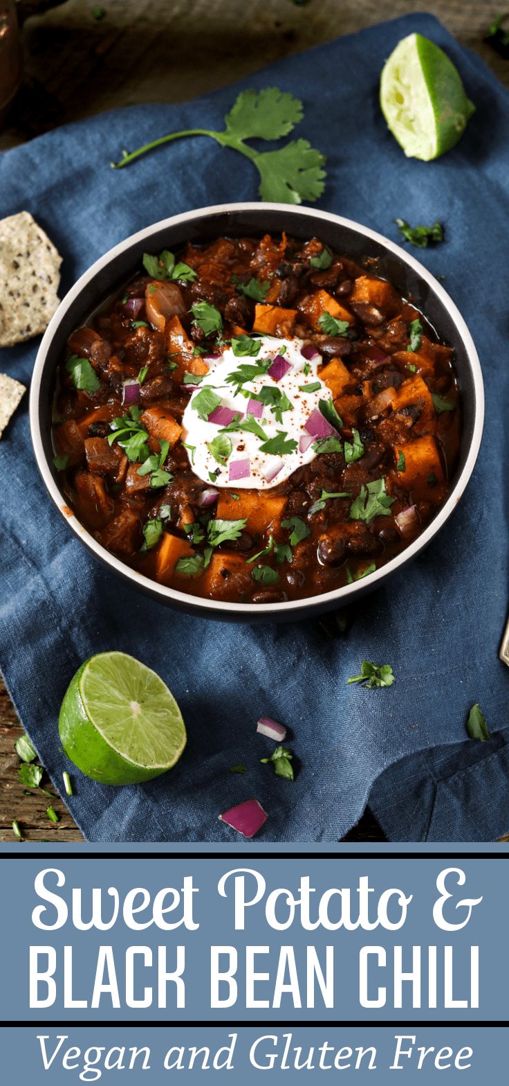 sweet potato and black bean chili in a bowl with sour cream on top, garnished with cilantro