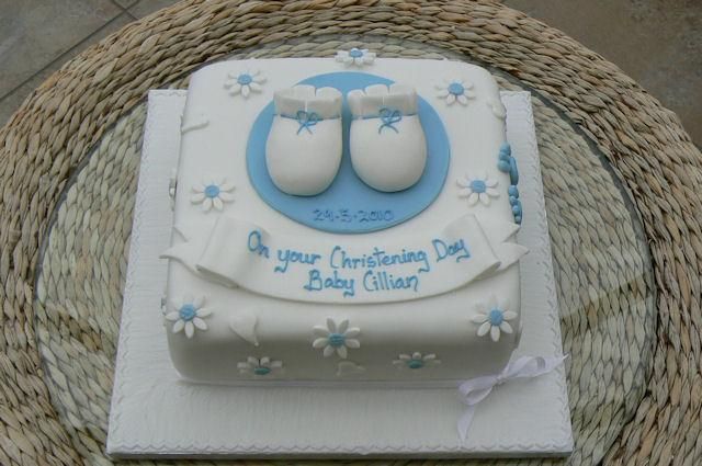 a baby shower cake with blue and white decorations on the top is sitting on a wicker basket